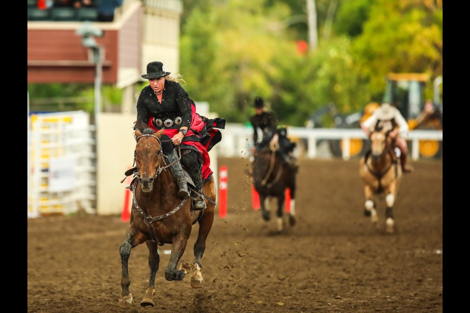 Sidesaddle racer and Foothills resident Claire Perks flies down the track in the lead at the Calgary Stampede on July 6. (BRENT CALVER/Western Wheel)