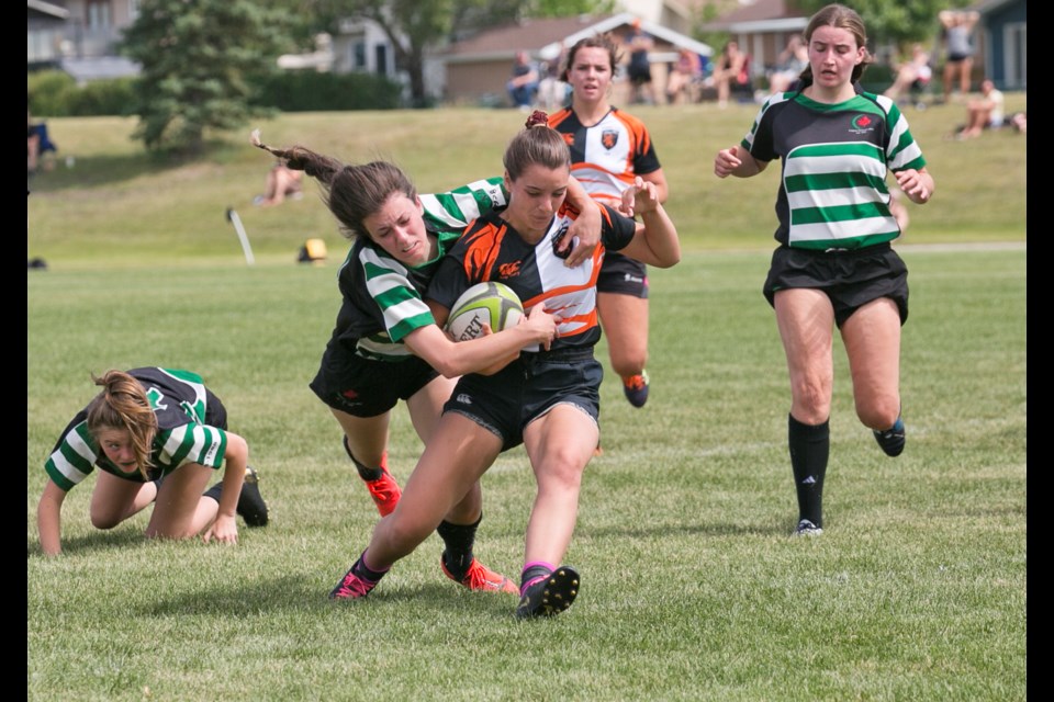 Blackie's Aurora Steel, seen here fighting off tackles with the Foothills Lions in the summer 2019 season, is headed to St. FX University in the fall.
(Remy Greer/Western Wheel)