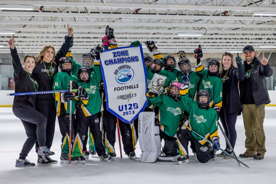 The Foothills Fierce poses with the U12 B Big Country Zone 2 banner after defeating the Indus Lightning by a 10-2 score in the final on March 18 at the Piper Arena, the first league or zone banner won by the Foothills Ringette Association in its history. Foothills’ U14 team repeated the feat with the U14 C zone championship on March 25. 