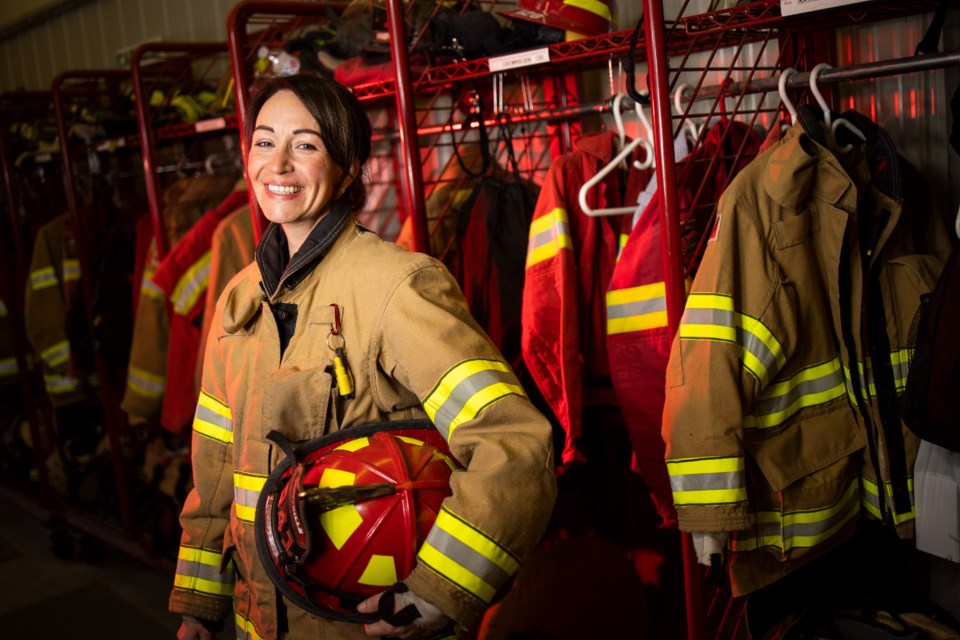 Longview firefighter and paramedic Lisa Mikkelsen dons her bunker gear at the Longview fire hall. (Brent Calver/Western Wheel)