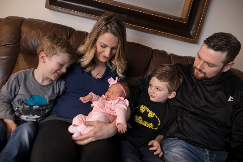 Okotoks New Years baby Irish rests in the arms of her mother Meagan Haberlack, with her husband Ryan and sons Lewis, left, and Sullivan in their home on Jan. 12.