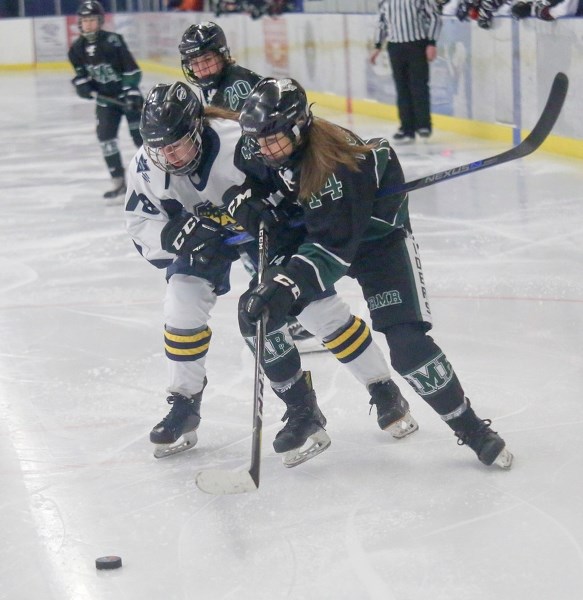 Rocky Mountain&#8217; s Kate Pickering battles with a North Central Impact in AFHL Bantam Elite action. Pickering is one 10 Raiders heading to the 2018 Alberta Winter Games.