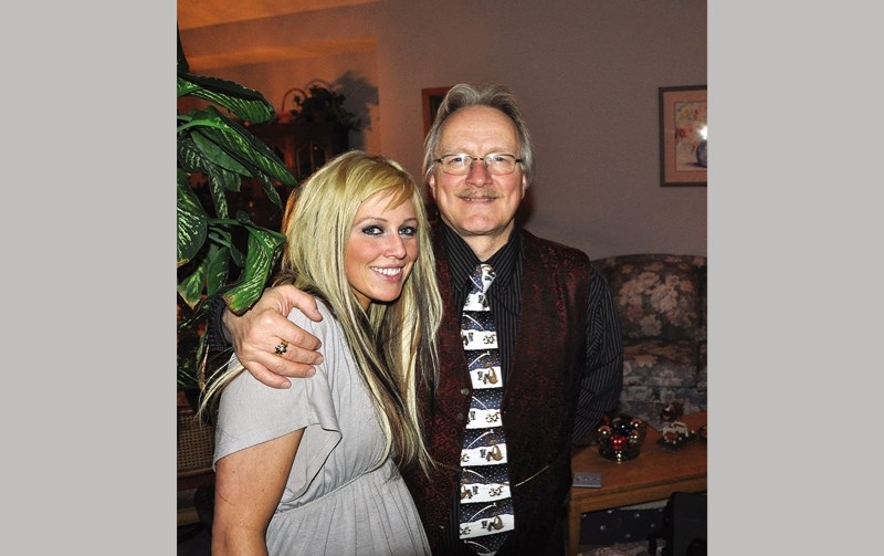 Ed Sands pictured with his daughter Amy in their Okotoks home before her 2012 death. The only person convicted in her death, Jesse George Hill, has been granted statutory
