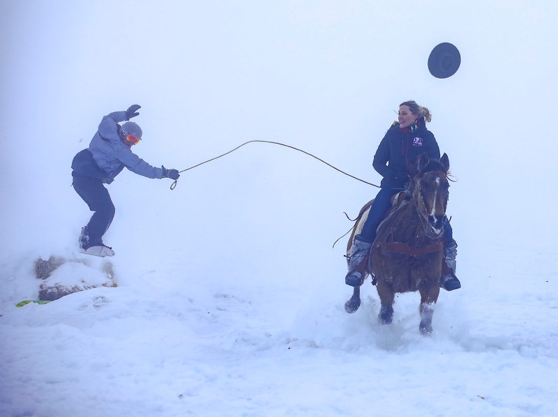 Sam Mitchell loses her hat while pulling snowboarder and Banded Peak brewer Matthew Berard over a jump at the Calgary Polo Club on Jan. 25.
