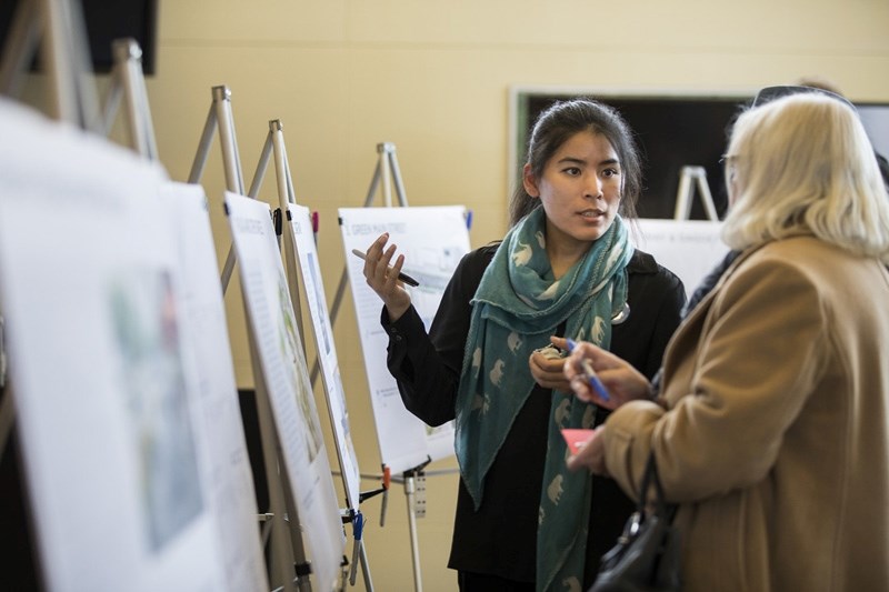 Rakshya Gauchan, a designer with O2 Planning and Design, discusses downtown planning concepts with visitors at an open house at the Okotoks Municipal Centre on Feb. 20.