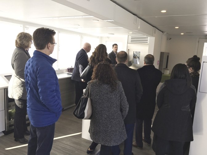 Town of Okotoks councillors, staff and community stakeholders tour the TELUS Future Home outside the Okotoks Recreation Centre on March 12. The home features smart technology 