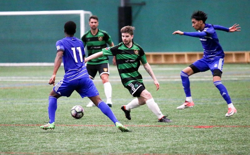 Foothills FC midfielder Mitch Piraux battles for possession with FC Edmonton during exhibition action on March 10. Foothills FC is relocating to Okotoks for the 2018 PDL