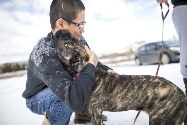 Darrell Dixon hugs Diamond after Pound Rescue spayed her as part of their outreach initiative in Eden Valley.