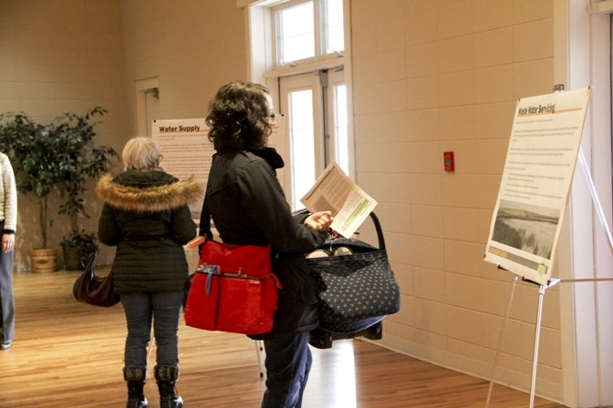 Natalie Muller checks out inforamtion panels at an open house for secondary suites in the MD held at DeWinton Hall on March 29.