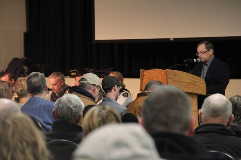 MD of Foothills Reeve Larry Spilak welcomes a crowd of more than 350 people at a rural crime meeting on April 10. The meeting panel included RCMP, rural crime watches, and