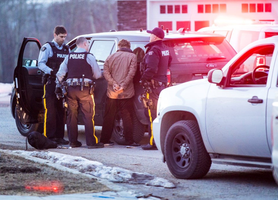 Okotoks RCMP take a man into custody in Sheep River Cove last night following an altercation in the parking lot on the north side of Okotoks Safeway where witnesses say they