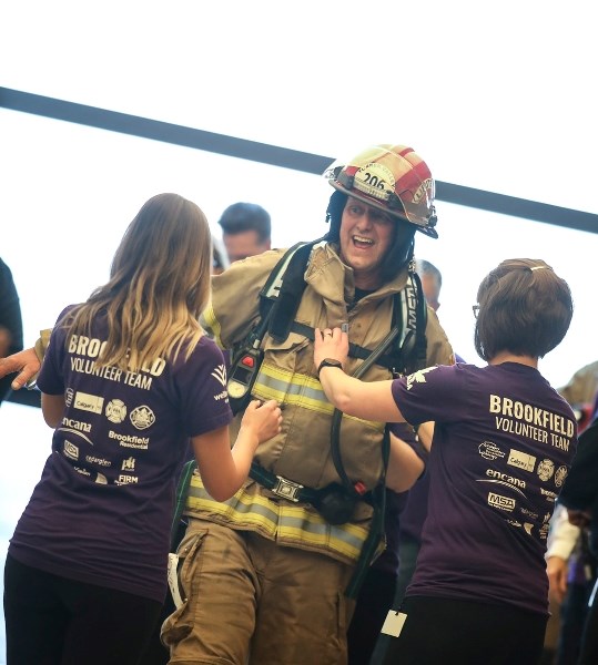 Turner Valley firefighter Willem Gersjes emerges on the 55th floor of the Bow building in downtown Calgary during the Firefighter Stairclimb Challenge on April 29.