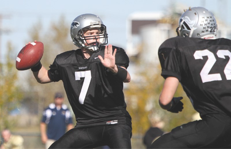 George McDougall Mustangs quarterback Jordan Mackenzie drops back in the pocket, Oct. 2. The Mustangs offence struggled against the high-powered Bow Valley defence, putting