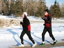 Helly Visser and Roger Davies demonstrate natural posture running at Fish Creek Park on Thursday. The pair has written Guide to Natural Posture Running, which is available