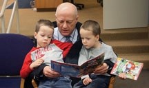 Caught in the act of reading Jan. 17 at the Okotoks Public Library are David Williams (centre) and his grandsons Jackson Shockey (left) and Tyson Shockey (right). People will 