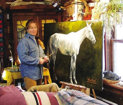 Foothills artist Jan Roenisch takes a step back while working on a painting of a horse named Blue Duck. Many of her animal paintings are now on display at the Longview