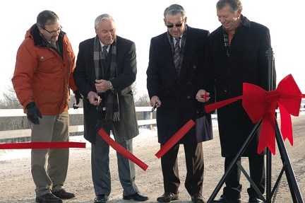 Left to right, Okotoks Mayor Bill Robertson, Highwood MLA George Groeneveld, former mayor Bill McAlpine and Macleod MP Ted Menzies cut the ribbon officially opening the 32