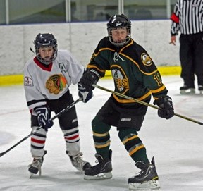 Okotoks Peewee AA Oilers forward Austin LeDuc (left) sets up in front of the Wheatland Braves net during Okotoks&#8217; 3-1 win on Saturday at the Murray Arena. LeDuc