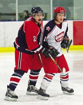 Bisons defenceman Michael Savage (left) jostles for position with Kris Keller of the Cochrane Generals during Okotoks&#8217; 7-4 victory on Sunday at the Murray Arena.