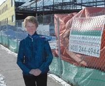 Retired teacher Mary Gillard checks out progress on construction of the Westmount School. The Foothills School Division will hold a contest to pick a name for the school and