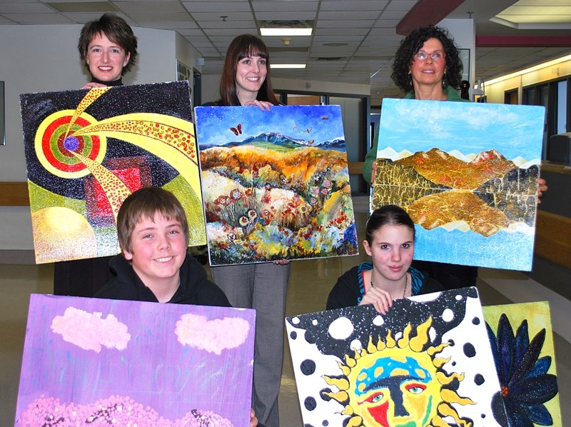 The painters behind the Ceiling Tiles Project at Oilfields General Hospital display their artistic masterpieces soon to be installed in the ceilings of patients&#8217; rooms. 