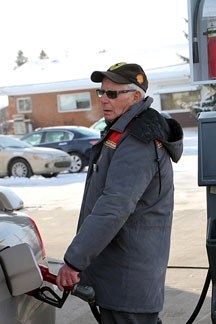 Harold Clark mans a pump on a frigid Monday morning at Hilltop Shell in Okotoks. The gas station attendant says the sustained bitterly cold weather locally has been a