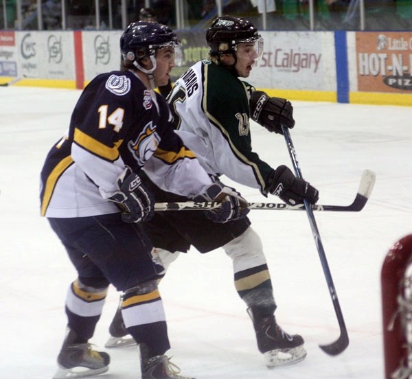 Okotoks Oiler Nolan Huysmans (right) jostles with Calgary Mustang Zach Beisel in front of the Mustangs&#8217; goal in the Oilers&#8217; 5-1 win on March 5. Okotoks has won