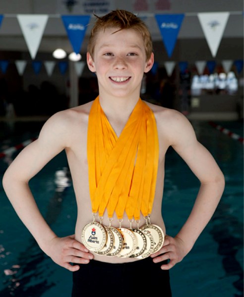 Foothills Stingray Finlay Knox displays the eight medals he won at a provincial meet on March 11-13 in Calgary.