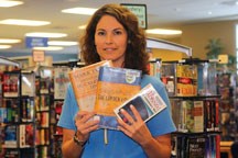 Assistant librarian, Caleigh Haworth, shows examples of books targeted for censorship prior to Freedom to Read week in February. The Okotoks Libray&#8217;s efforts in