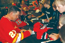 Sheldon Kennedy signs autographs at last year&#8217;s Flames Alumni Game and Gala at the Centennial Arena. Kennedy and other Flames alumni will place a game against Okotoks