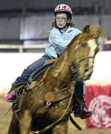 A young rider navigates the obstacle course with her horse during the Future Cowboys and Cowgirls Rodeo Society finals at the Okotoks Ag Society Arena on April 16.