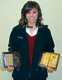 Highwood Female Midget Raiders AAA goaltender Jenni Schmidt poses with her two trophies, the MVP and Oiler awards, she won at the Okotoks Oiler Athletic Association Awards
