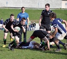 Holy Trinity Academy Knight Aidan Coyles tries to get through the G.W. Graham high school defenders in a rugby game in Victoria, B.C. in late April. The Knights lost the game 