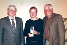 Okotoks Rotary Club president Bill McAlpine presents Bill and Karen McFarlane with the Integrity Award at a special banquet held April 20.