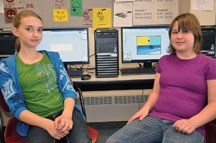 Kathleen Kilcommons, left, and Kyra Knight, right, work on creating optical illusions with the new school computers at John Paul II Collegiate in Okotoks.