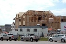 Construction crews work on a section of the Tudor Manor, being built by the Brenda Stafford Society, in northwest Okotoks.