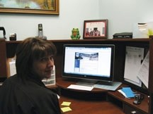Brenda Thompson, vice-president of the Sheep Creek Arts Council, showing the new logo and website.