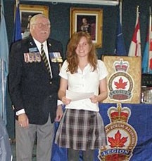 Comrade Dave Horrocks of the Turner Valley Legion presents a special honour to Zoe Osbourne of Edison School for her accomplishments in the annual Legion Remembrance Poster