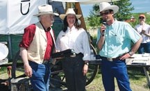 Cluny Alberta&#8217;s Leo Maynard (left) is rewarded for his outdoor cooking excellence by Marian Anton (centre) and Mike McLean (right) during last year&#8217;s Chuckwagon