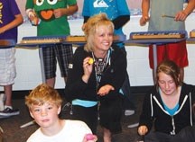 BOF selection as Best teacher, Bonnie Kentch (centre) kneels among music students performing an upbeat tune at Dr. Morris Gibson School on June 14. Also pictured are Kevin