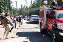 A young spectator gets a cooling blast of water from the Redwood Meadows Fire Department during the 2010 Bragg Creek Days parade. The hamlet welcomes visitors for its annual