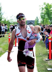 John White of Calgary crosses the finish line first at the Natural High Charity Triathlon on Saturday, July 9. The race successfully raised over $15,000 for KidSport and