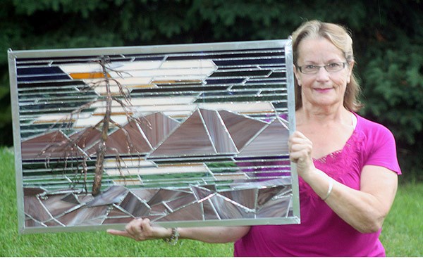 Okotoks artist Shirley Paradis diplays an original stained glass and metal piece she did in the style of Group of Seven painters. The works of the esteemed landscape artists