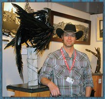 Perched next to his work &#8220;Nevermore&#8221; Okotoks area artist Michael Perks enjoys the attention that comes with being named best new artist at the Calgary