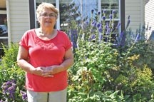 Vivian Hirsch, an executive for the Okotoks Garden Club, stands in front of her gorgeous garden. The Okotoks Garden Club will be featuring new speakers with meetings