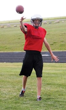 Holy Trinity Academy Knight quarterback Ryan Hassler practices his throwing mechanics at the team&#8217;s first practice of the 2011 season. The Knights play their first game 
