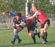 Foothills Lion Kevan Yeats, right, gets set to tackle a Calgary Canucks winger during the first half of the Sept.14 game between the Calgary Rugby Union third division rivals.