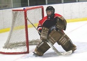 Okotoks Bisons netminder Tyler Hughes gets in position to make a save during the Bisons&#8217; 7-3 victory over the Banff Academy Bears on Sept. 18. Hughes made 15 saves on
