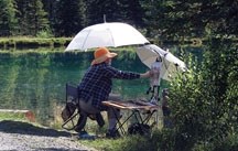 Dorothy Chisholm practices the art of en plen air painting at Forget-Me-Not pond near Calgary. The outdoor artist will be part of the annual Paint-Out at her beloved Leighton 
