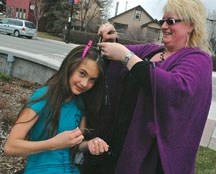 Lawna Frank gives High River teen Victoria Lima-Morley some &#8220;hair bling&#8221; earlier this year at the Market Square event in the Olde Towne Okotoks Plaza as part of